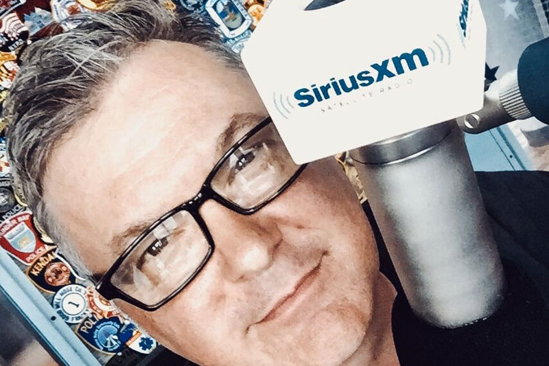 Image of Buzz Brainard on a SiriusXM mic 